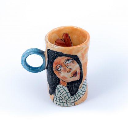 girl holding a bird portrait painted on ceramic cup