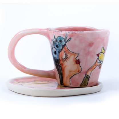 handpainted pink ceramic espresso mug portraying a girl and a bird